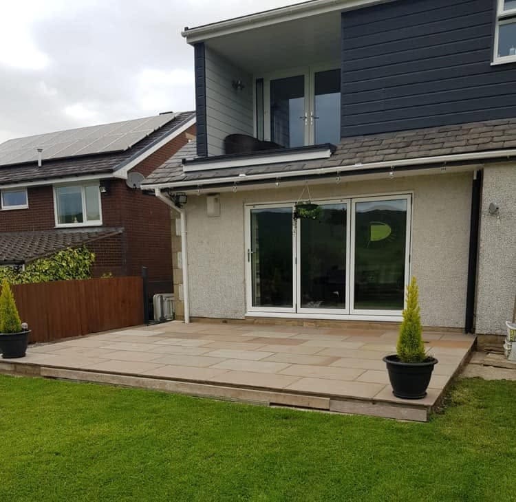 Stone patio outside modern bi-fold doors
