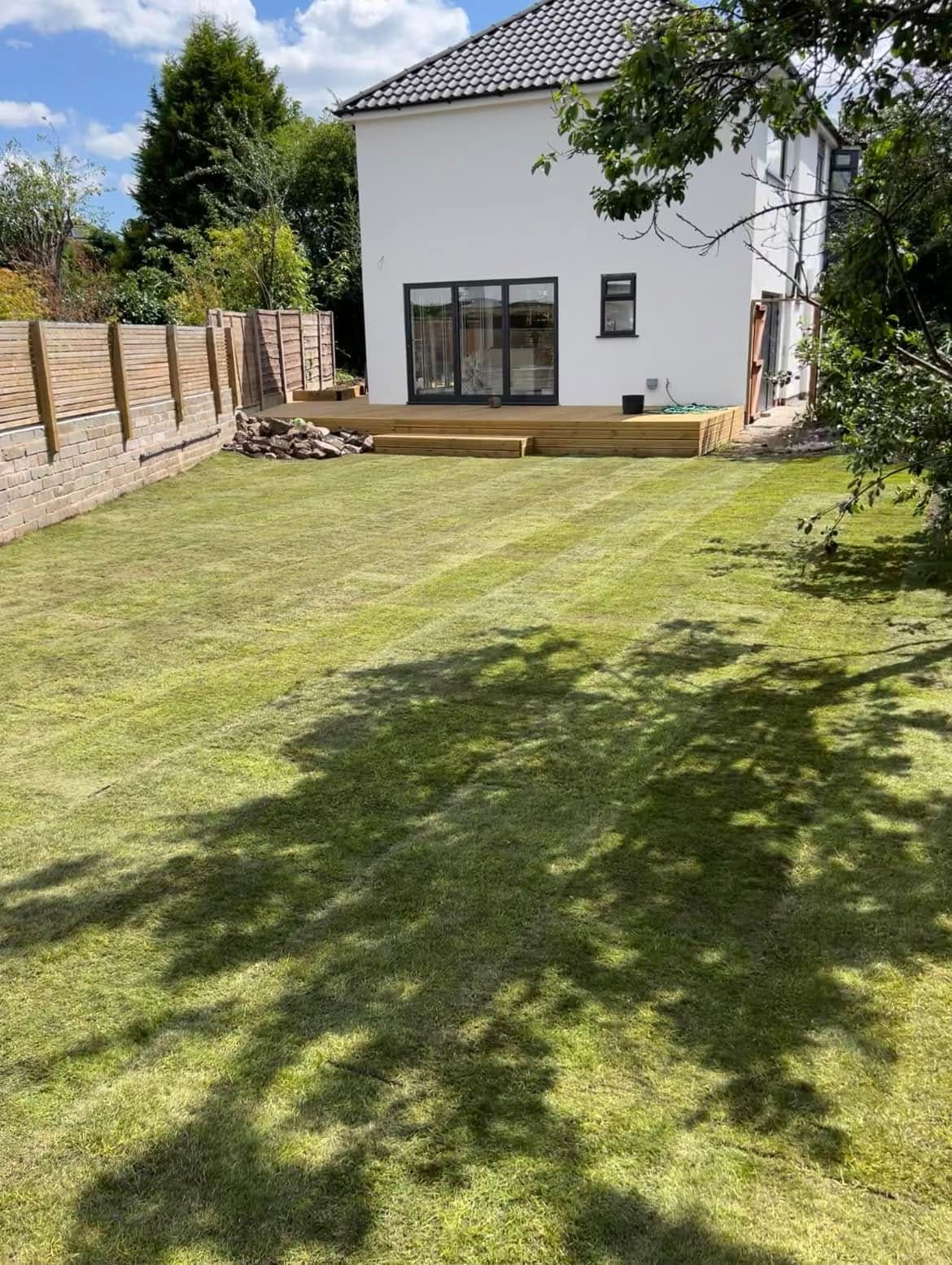 After: full lawn turfing with new timber decking