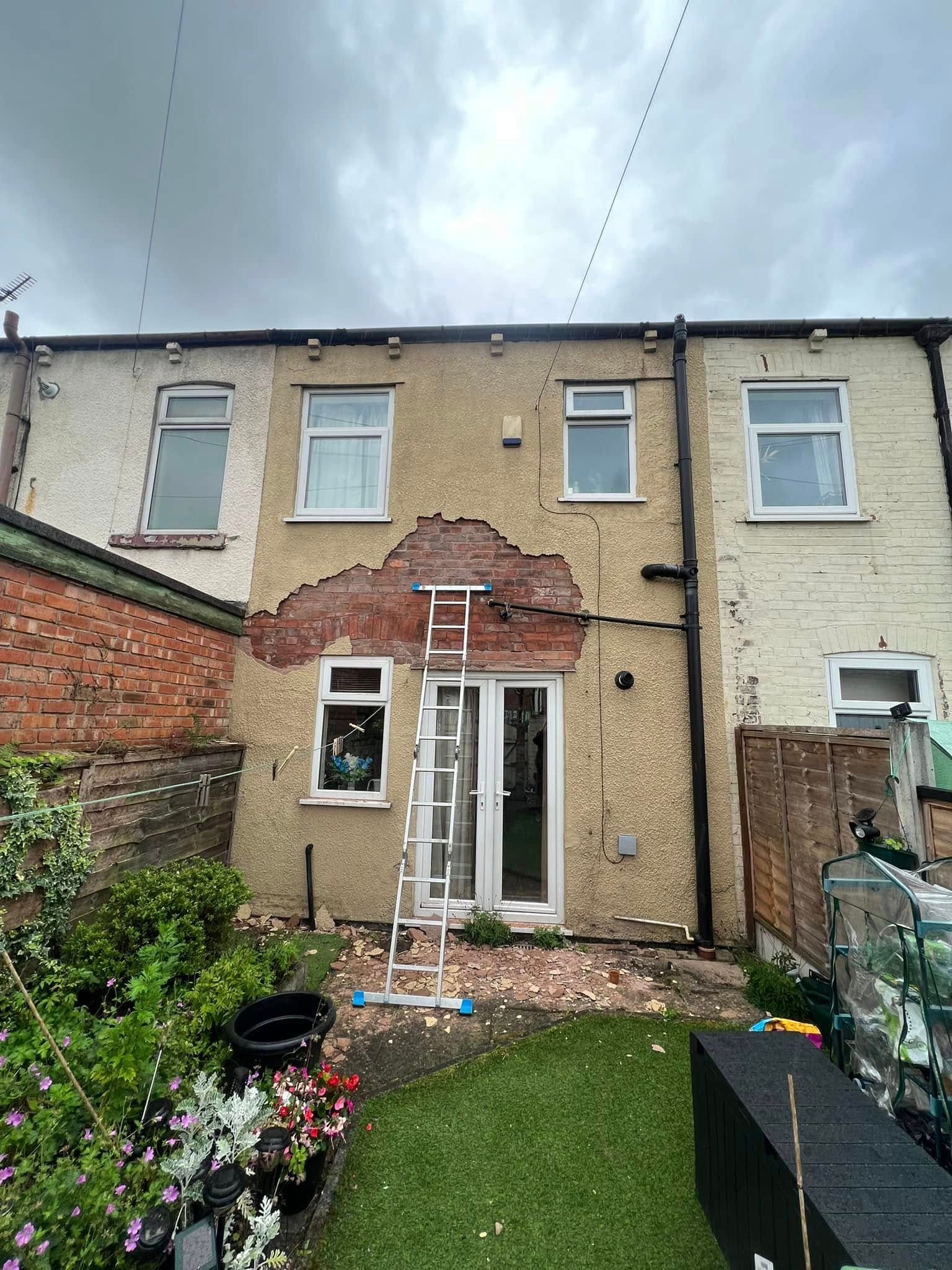 Before: rear of a terraced house needing repair