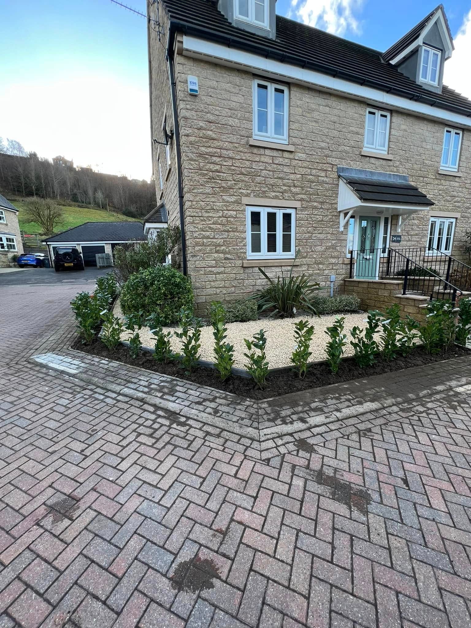 After: landscaped garden with striped turf, gazebo and conservatory